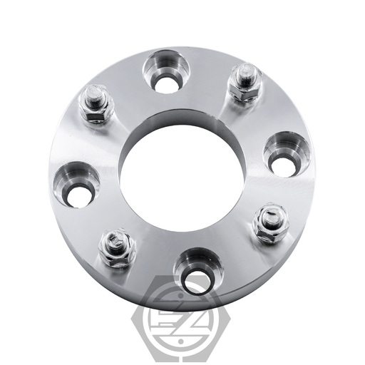 The Wheel Adapter 4 Lug 110 to 4 Lug 137 (Pair) is a circular metal adapter, featuring five bolt holes with attached studs. Designed for wheel fitment adjustments, it has a silver, reflective finish and an elegantly placed logo at the bottom center for a seamless fit.