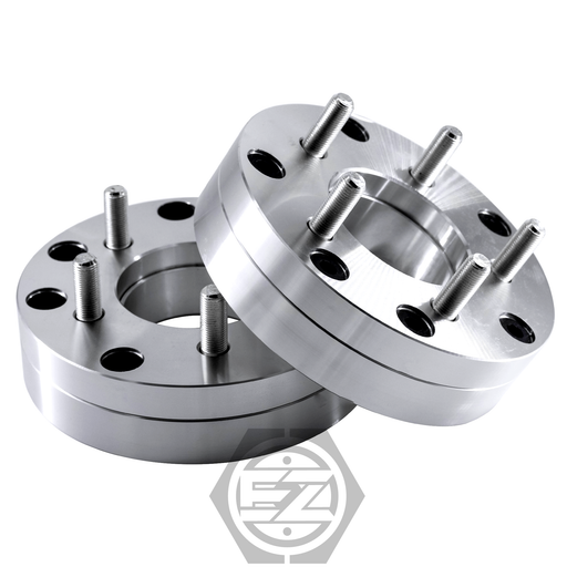 A pair of Wheel Adapter 4 Lug 130 to 5 Lug 112 spacers are displayed against a white background. Stacked diagonally, they feature circular holes and a logo at the bottom center, ideal for upgrading your Mercedes wheels.