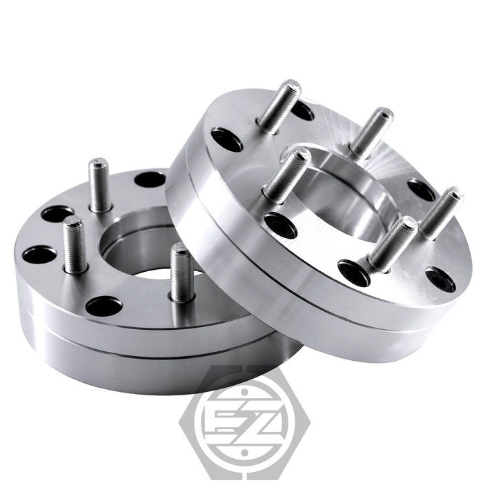 Two silver wheel spacers, CNC machined from 6061 T6 billet aluminum with a 5x4.5 bolt pattern, are stacked slightly offset against a white background with a partially visible logo at the bottom. Product: Wheel Adapter 4x110 To 5 Lug 4.5 (Pair).