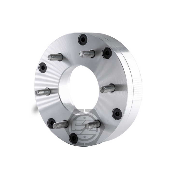 The Wheel Adapter 5 Lug 5.5 to 6 Lug 5.5, with a thickness of 2, is a silver metal automotive spacer featuring six bolts and black fasteners, designed for Chevy wheels. It has a central hole and logo etching, ideal as a conversion adapter for various bolt patterns.