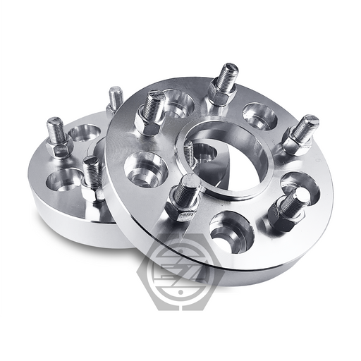 Two Hub Centric Wheel Adapters for BMW (5x120) are CNC machined from aluminum with bolt holes and attached studs. Positioned one in front of the other on a white background, their shiny finish and a partially visible logo highlight these precision-engineered components.