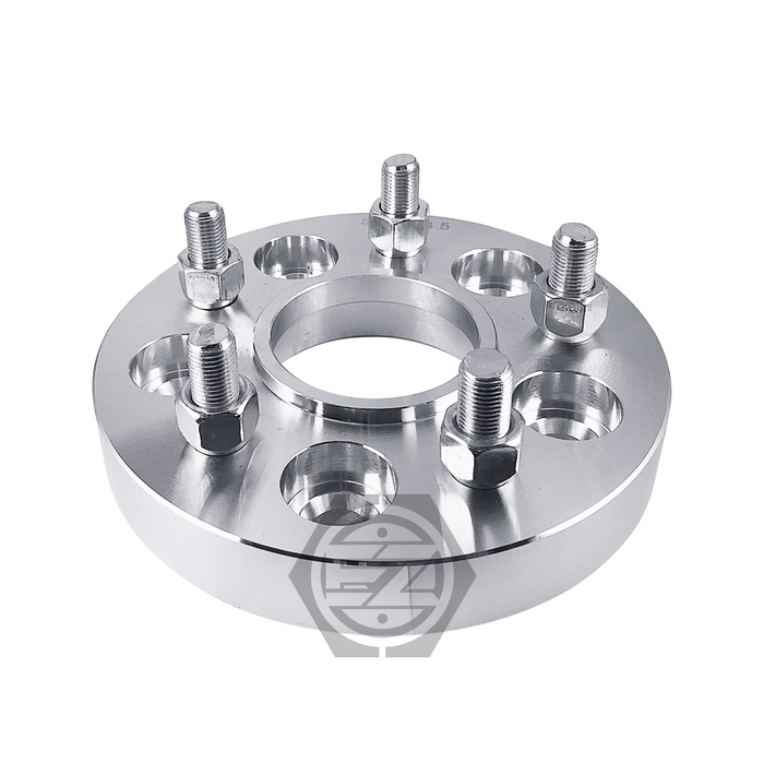 The Hub Centric Wheel Adapter 5 Lug 100 for Toyota Scion is a shiny silver wheel spacer, CNC machined from 6061 T6 billet aluminum, featuring multiple bolt holes and five open end lug nuts installed on top. Its hollow center fits onto a wheel hub with a logo partially visible beneath the spacer.