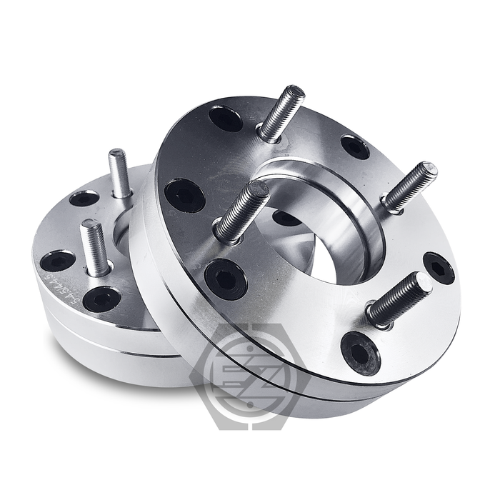 A pair of shiny, metallic wheel adapters made from CNC machined billet aluminum are stacked on a white background. Designed for a 5 lug adapter setup, they feature multiple bolts and holes with a visible logo.