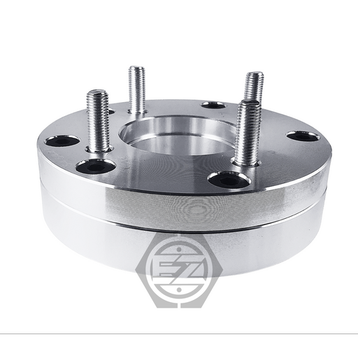 Close-up of a Wheel Adapter 5 Lug 4.5 To 4 Lug 4.5, featuring protruding studs, circular holes, and a reflective surface. Crafted from CNC machined billet aluminum, it is set against a white background with an abstract logo at the bottom center.