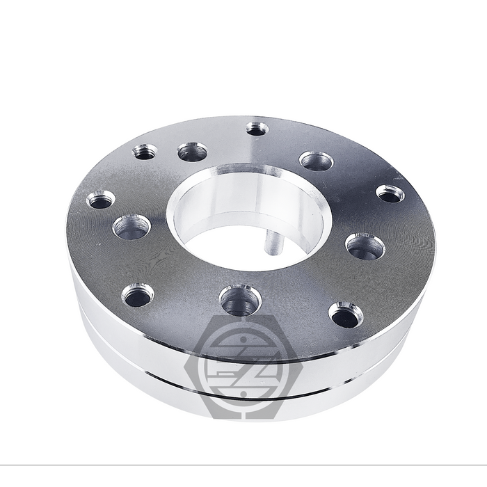 A CNC machined billet aluminum Wheel Adapter (5 Lug 4.5 To 4 Lug 4.5, Thickness 1.75) features a central and multiple circular holes with a polished finish and logo beneath the perimeter holes.