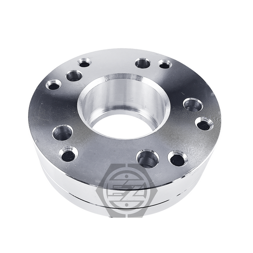 The Hub Centric Wheel Adapter 6x5.5 to 5x4.75 (2 thick, pair) is a metallic cylinder made from CNC machined billet aluminum featuring multiple holes around a central opening against a white backdrop, with a stylized logo at the bottom center.